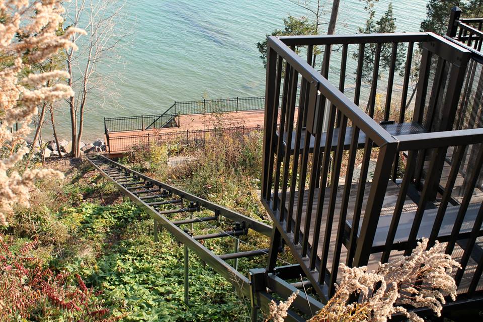 Classic Hoist galvanized track running down the bluff to a lakeside landing