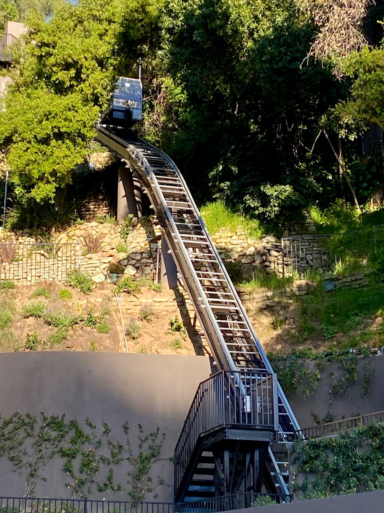 Hill Hiker enclosed car on curved captured-rail track down the hillside
