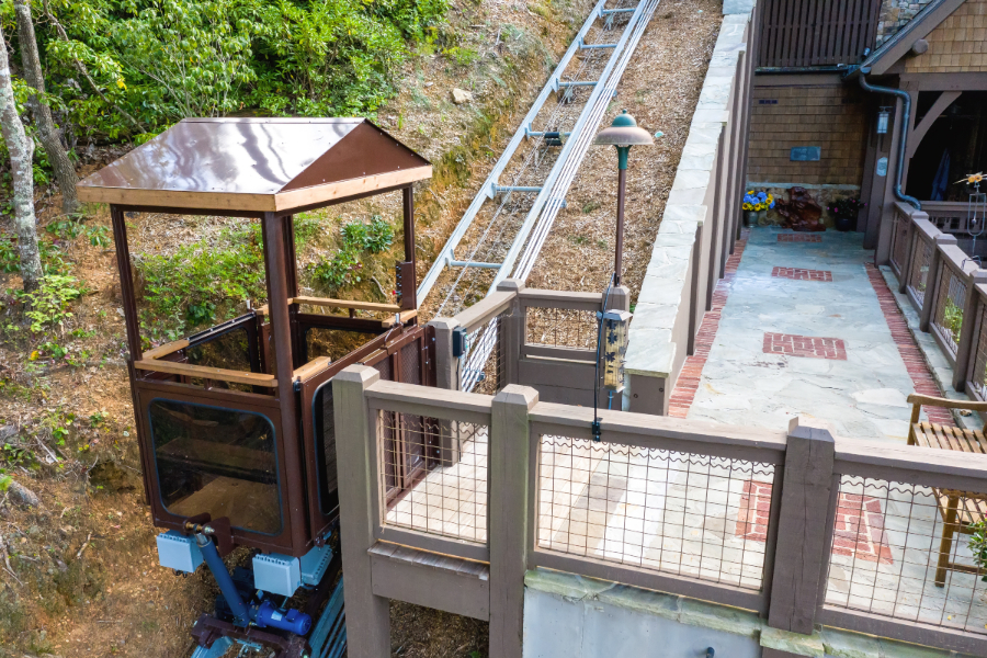 Roofed Ultra Hoist carriage on the track beside a hillside landing